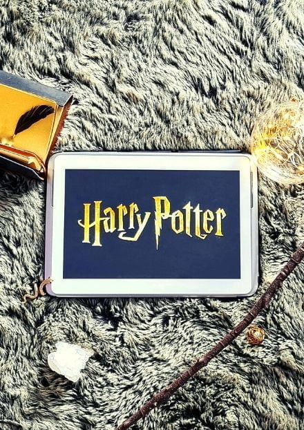 Harry Potter logo on tablet surrounded by trinkets