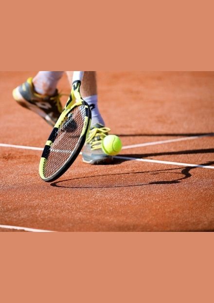 Tennis ball and racquet on tennis court